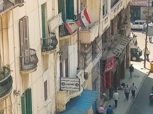 Alessandria, Fouad street nel centro storico della città con bandiere indicanti la presenza di diverse nazionalità (ph. Veronica Merlo)
