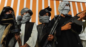 Former Taliban fighters stand with their weapons during a ceremony after joining Afghan government forces in Herat on August 7, 2013. About 100,000 foreign combat troops, 68,000 of them from the US, are due to exit by the end of 2014, and NATO formally transferred responsibility for nationwide security to Afghan forces a week ago. AFP PHOTO/ Aref Karimi        (Photo credit should read Aref Karimi/AFP/Getty Images)