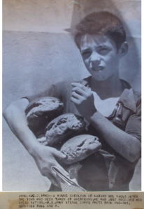 £ agosto 1943. Mazara del Vallo. Un bambino riceve la razione di pane per la sua famiglia dall'Esercito alleato (foto US. Army, coll. Serra)
